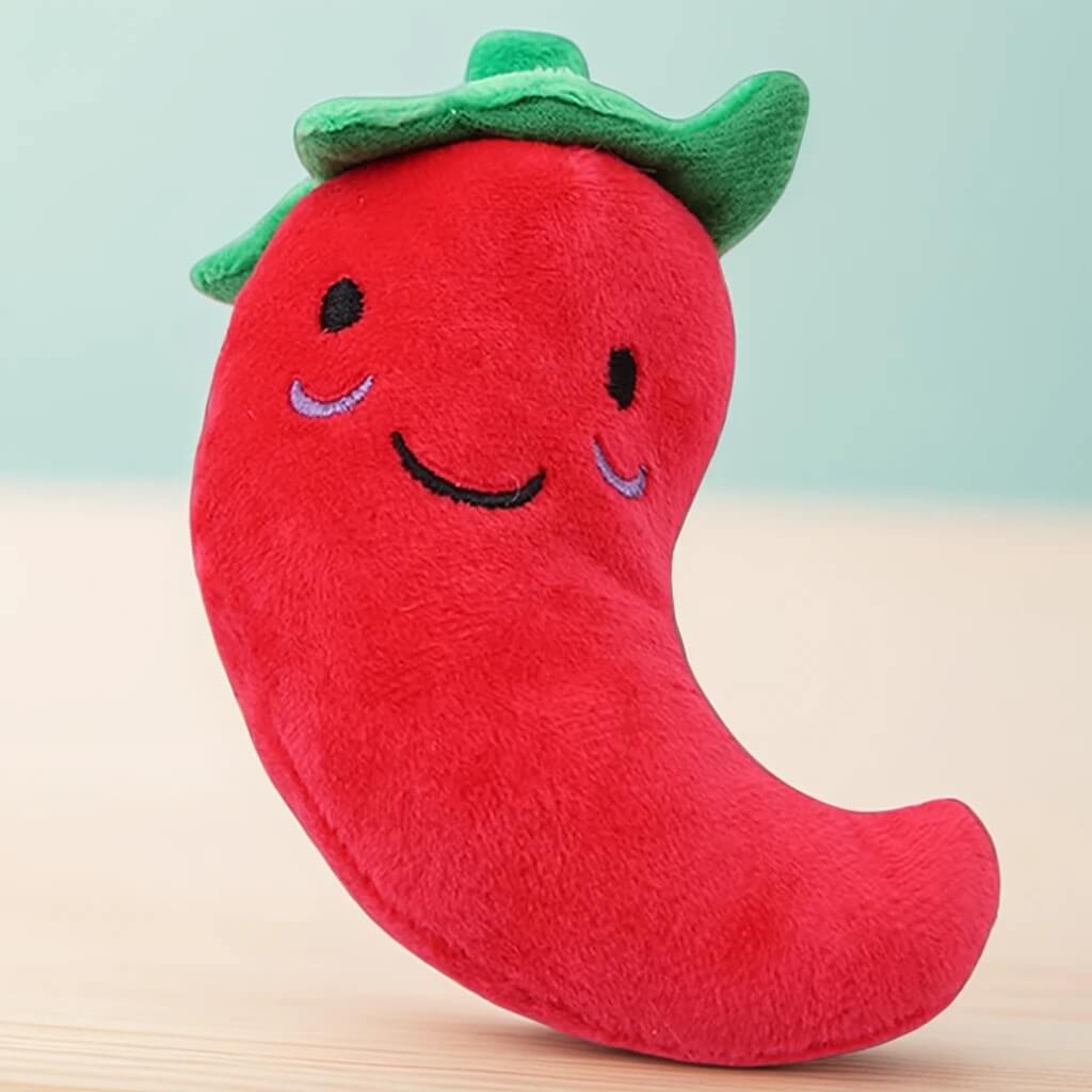 Jouet en peluche pour chiens et chats en forme de piment rouge souriant. Conception douce et sécurisée, parfait pour stimuler l'activité des animaux.